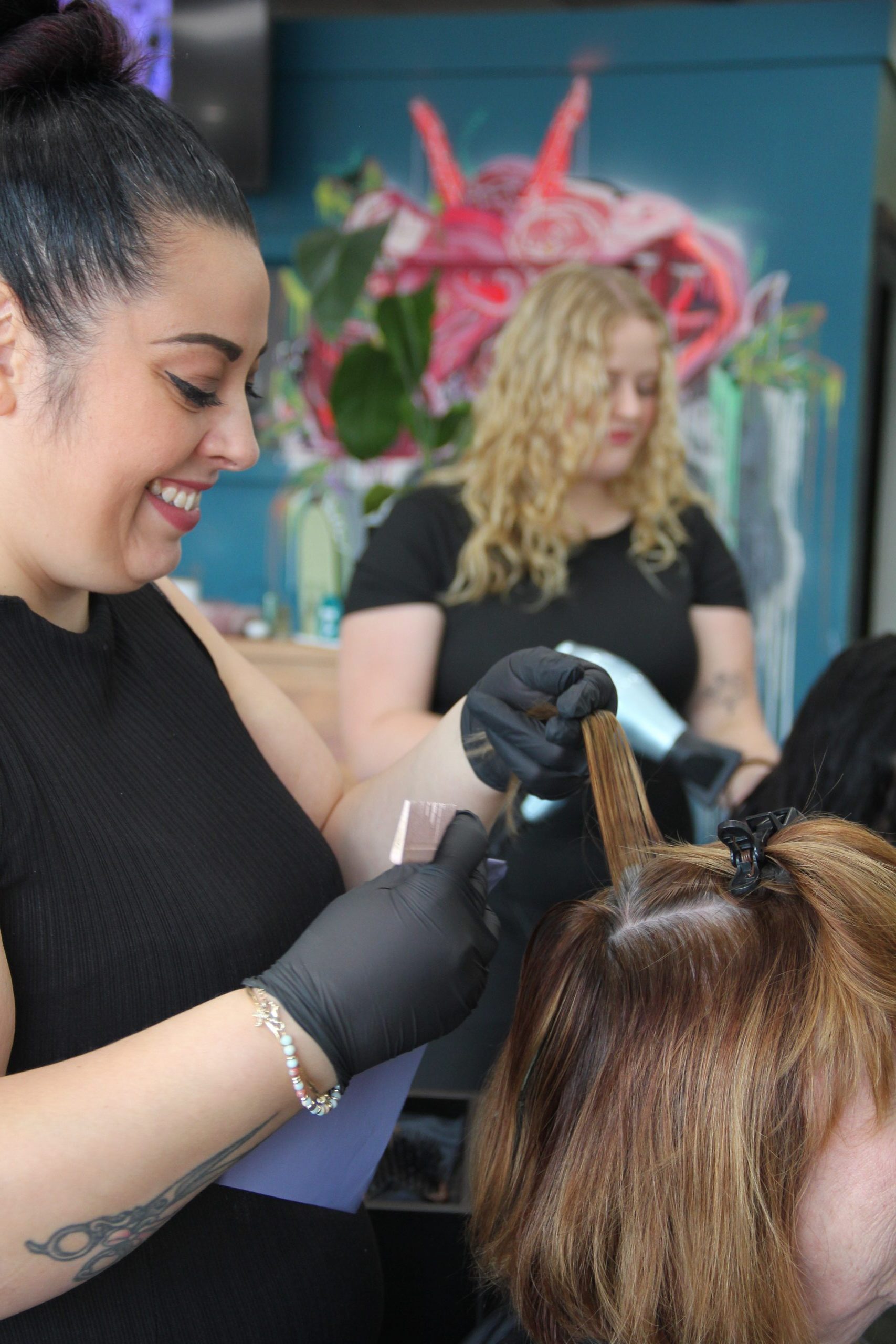 Barb colouring hair on client at salon eve